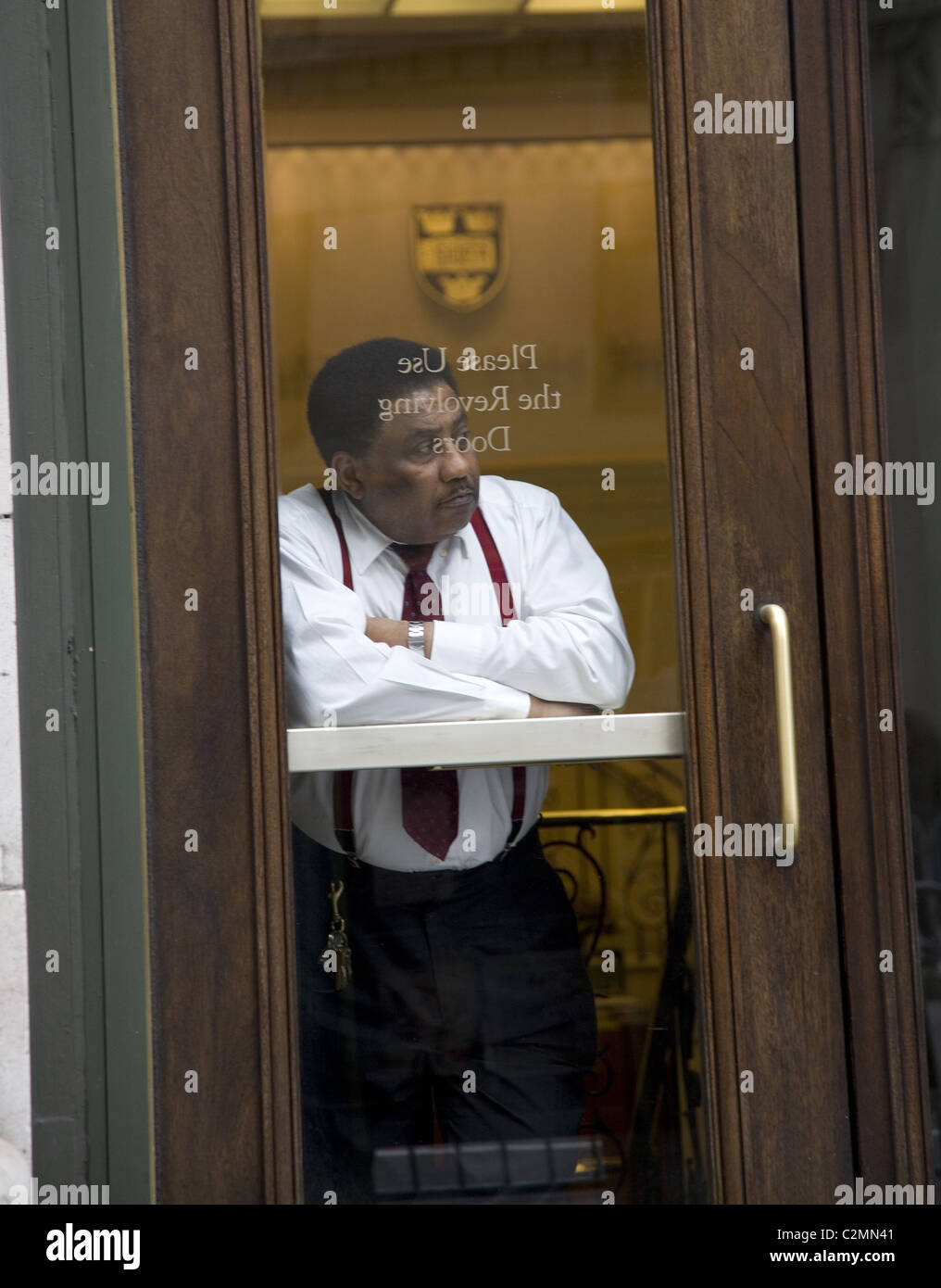 2011 Office building doorman, Madison Avenue, New York City Stock