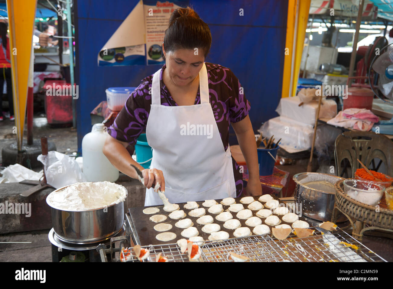 A Thai woman making crispy cakes on a market stall, Phuket, Thailand Stock Photo