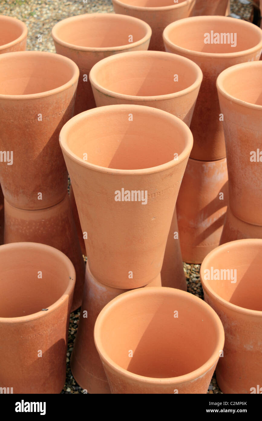 Tall terracotta flower pots stacked together. Sussex England UK Stock