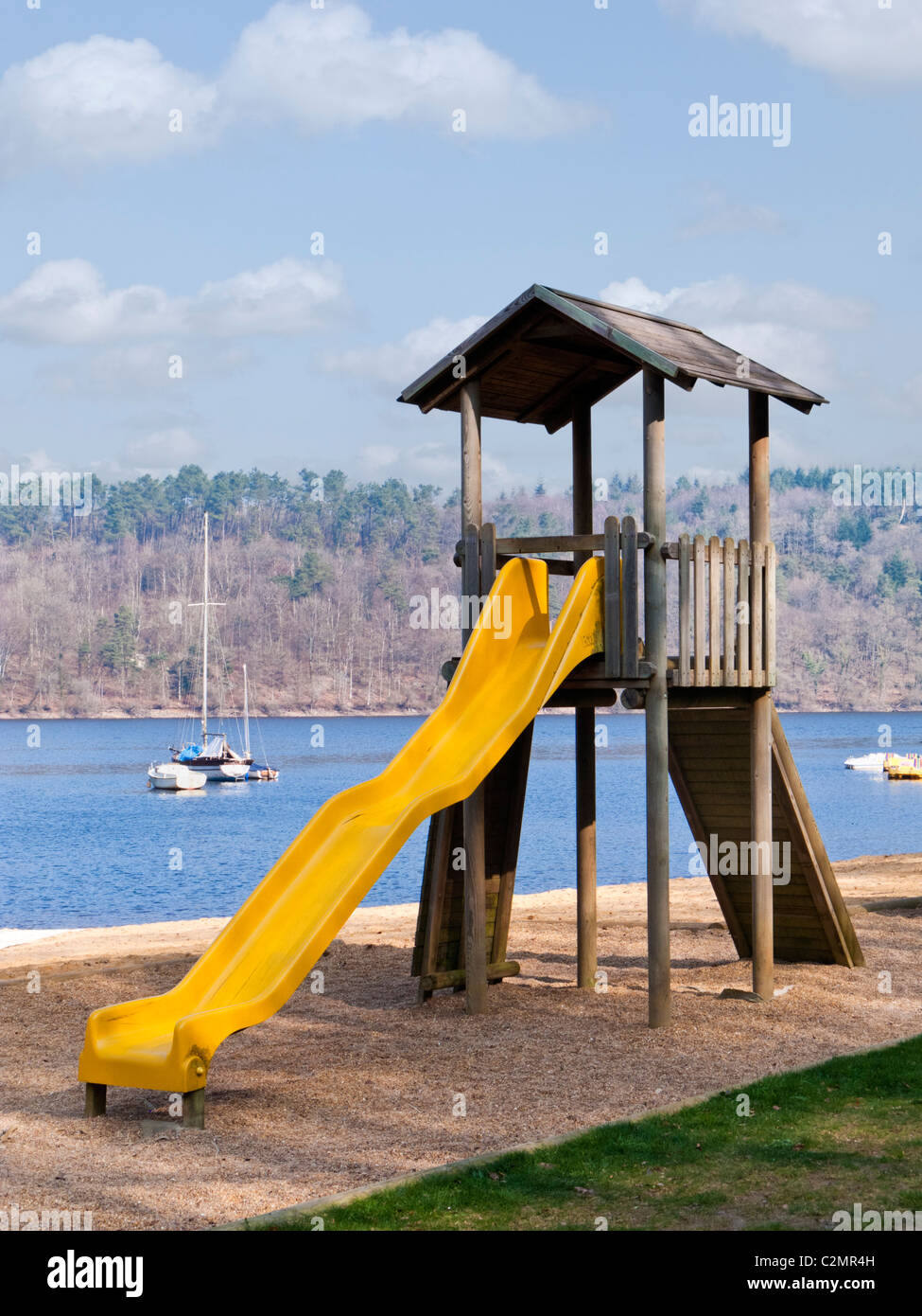 Slide in children's playground beside a lake Stock Photo