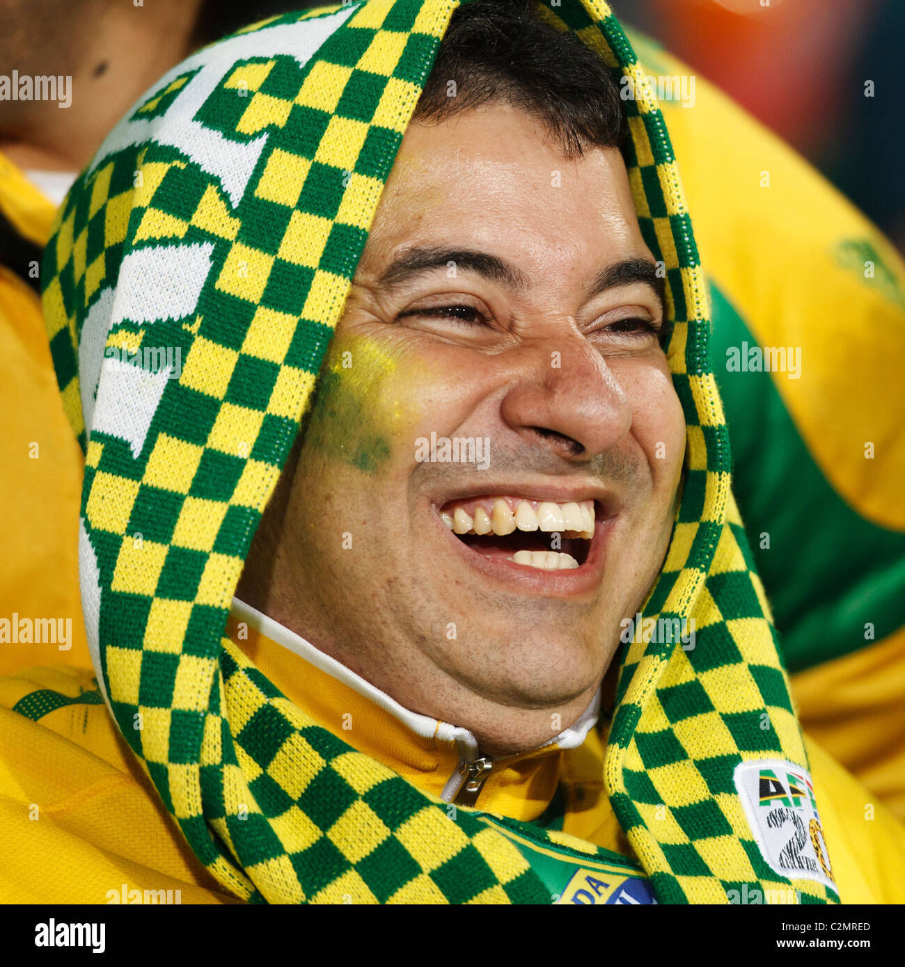 A Brazil supporter in the stands at Ellis Park Stadium smiles at a 2010 World Cup football match between Brazil and North Korea. Stock Photo