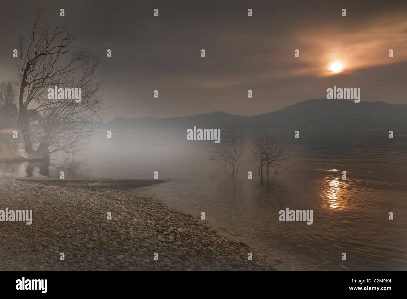 Fog over the Lake Maggiore during sunset Stock Photo