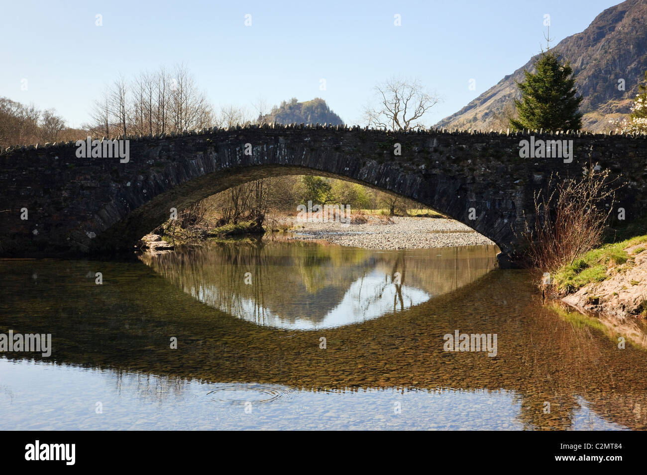 Castle Crag reflected in a bridge arch over the River Derwent in Borrowdale in Lake District National Park. Grange, Cumbria, England, UK Stock Photo