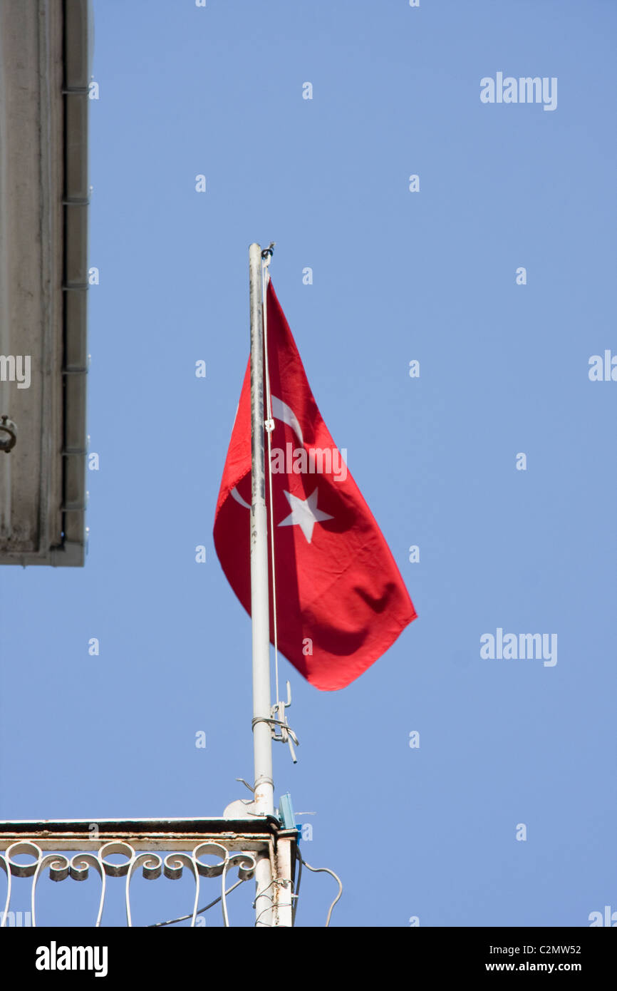 Red Turkish Flag flying against a blue sky Stock Photo