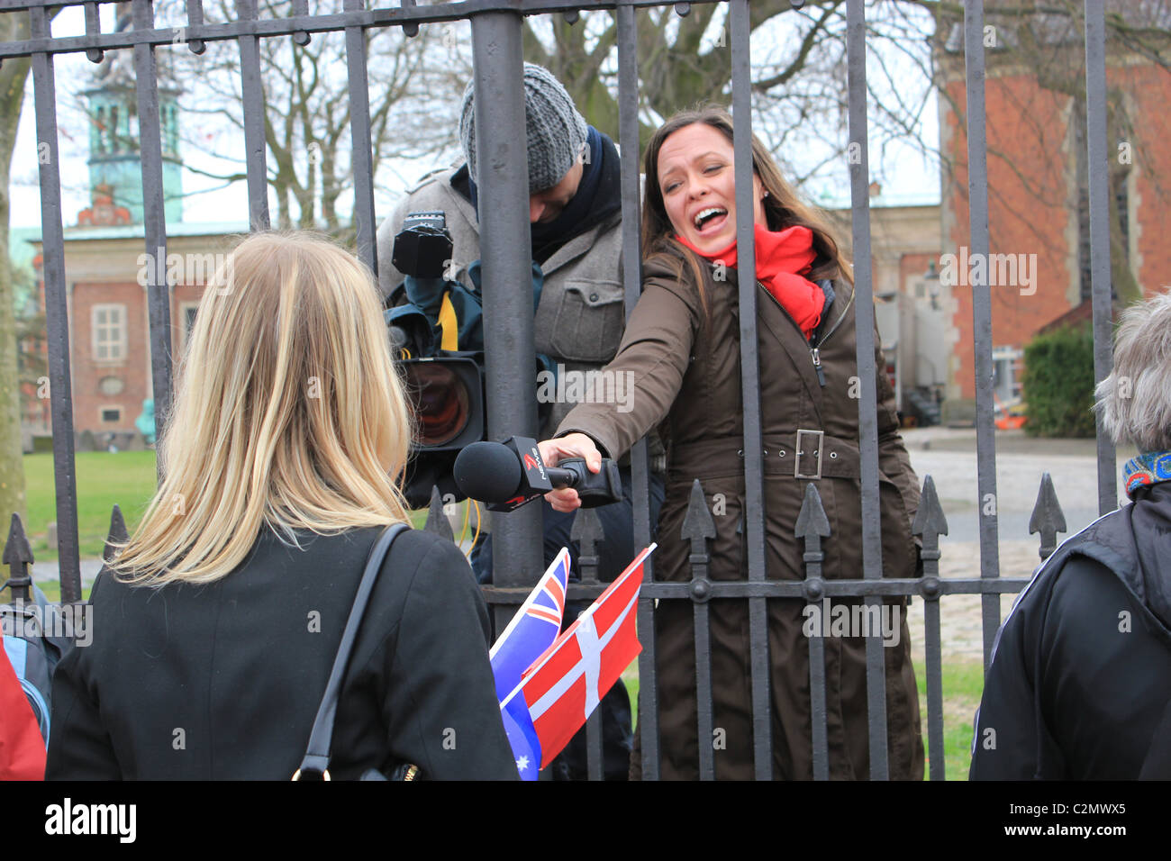 An Australian TV reporter interviews spectators at the Danish royal twins baptism. Behind there is the Holmen´s Church. Stock Photo