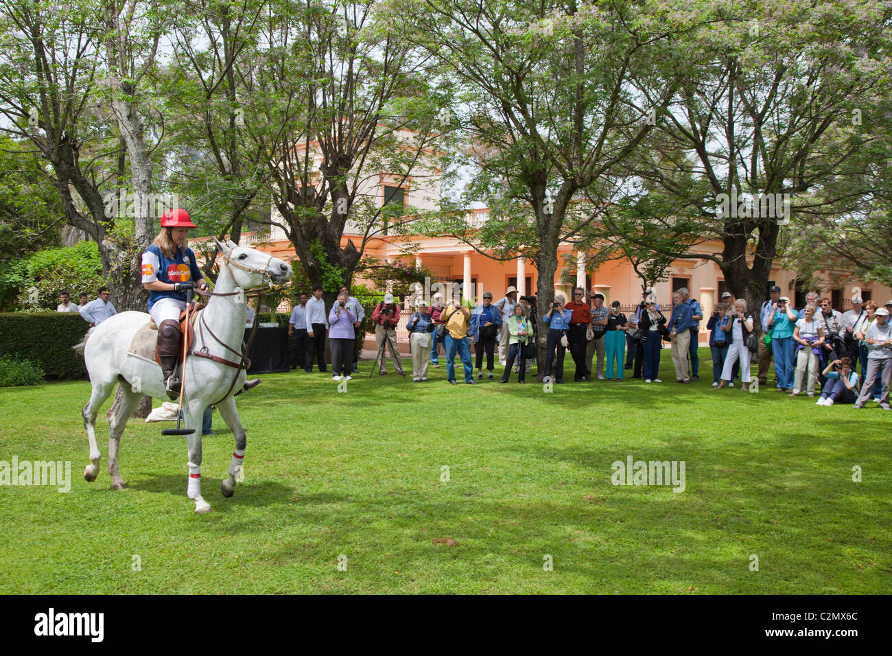 Tourists watching a polo pony and rider demonstration, La Carabassa, Argentina Stock Photo