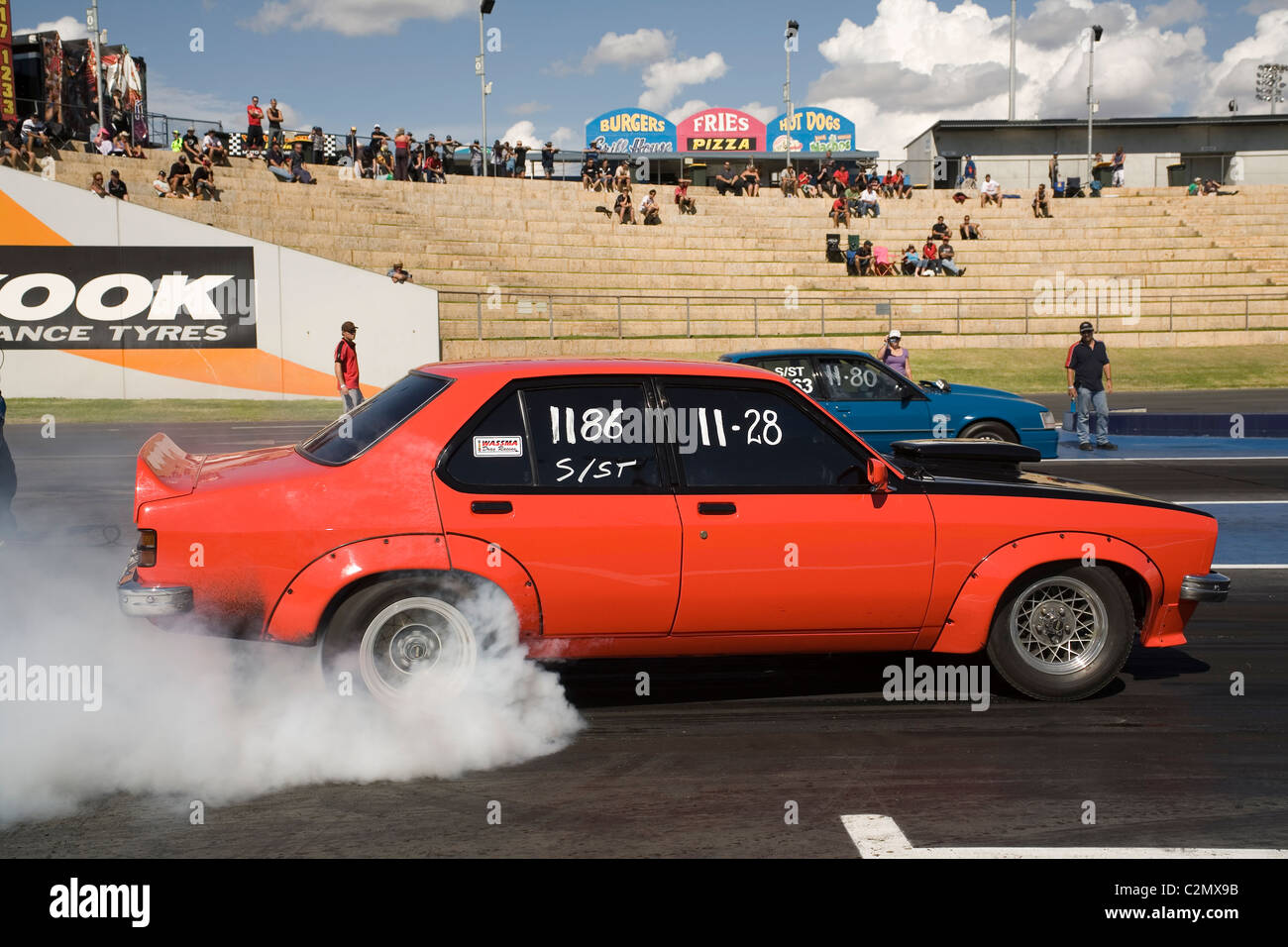 Classic 1970s model Australian Holden Torana performing a burnout at an Aussie drag race meeting. Stock Photo