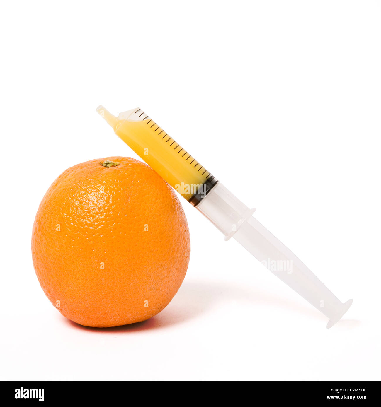 Orange with syringe filled with juice - vit C dose Stock Photo