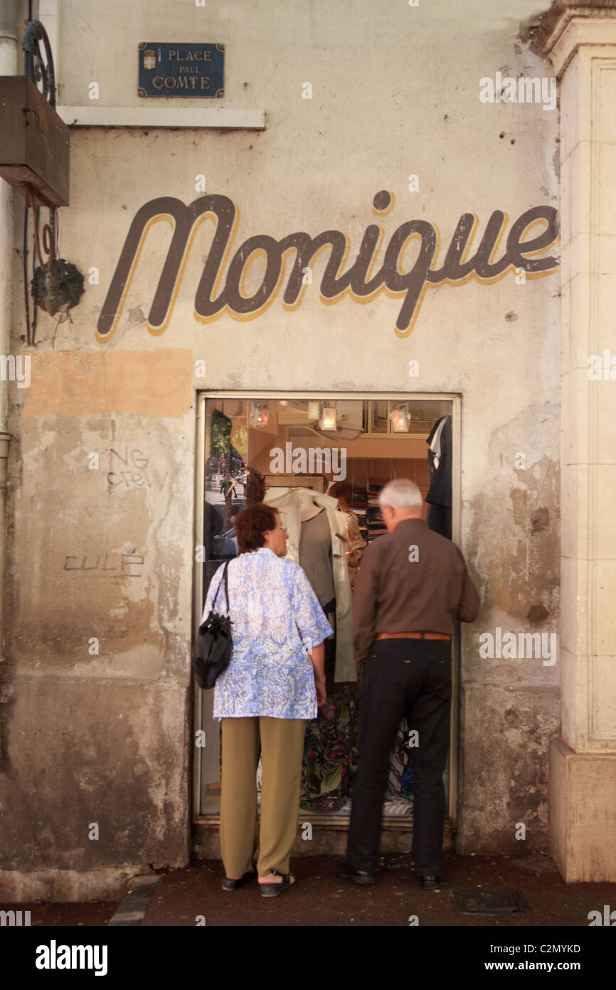Couple watching clothes in an old shop of Toulon Stock Photo