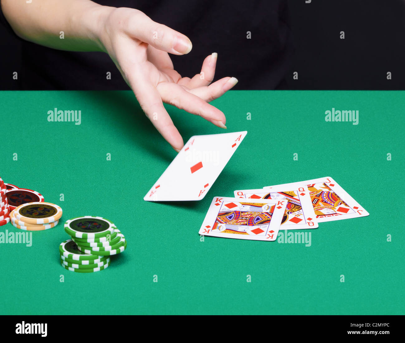female hand with a winning card combinations. Green tables, chips