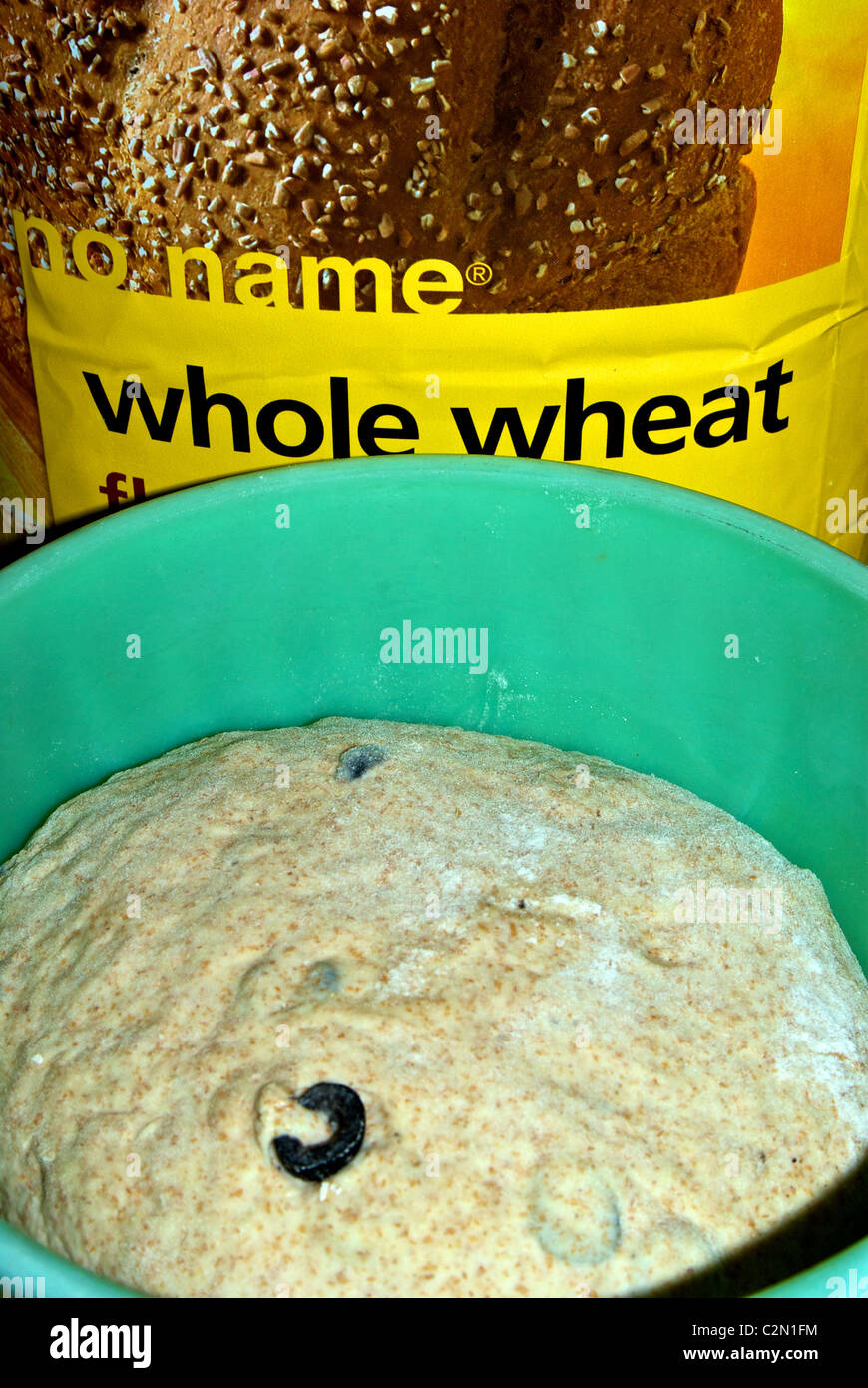 Bowl whole wheat flour pizza bread yeast dough with sliced black olives