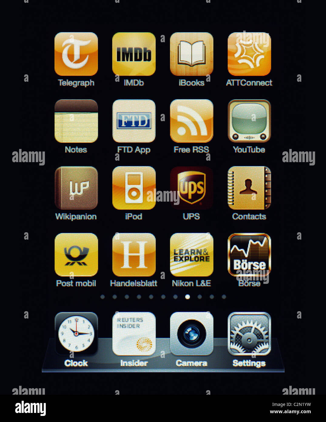 Image of the iphone touch screen. Display shows a collection of useful apps with yellow color scheme. Stock Photo