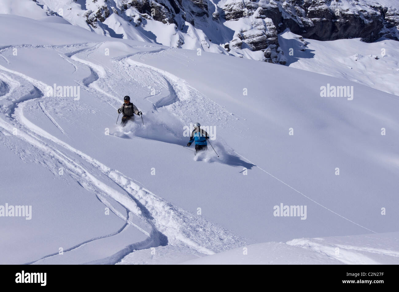 Two skiers off piste, Wengen, Switzerland Stock Photo