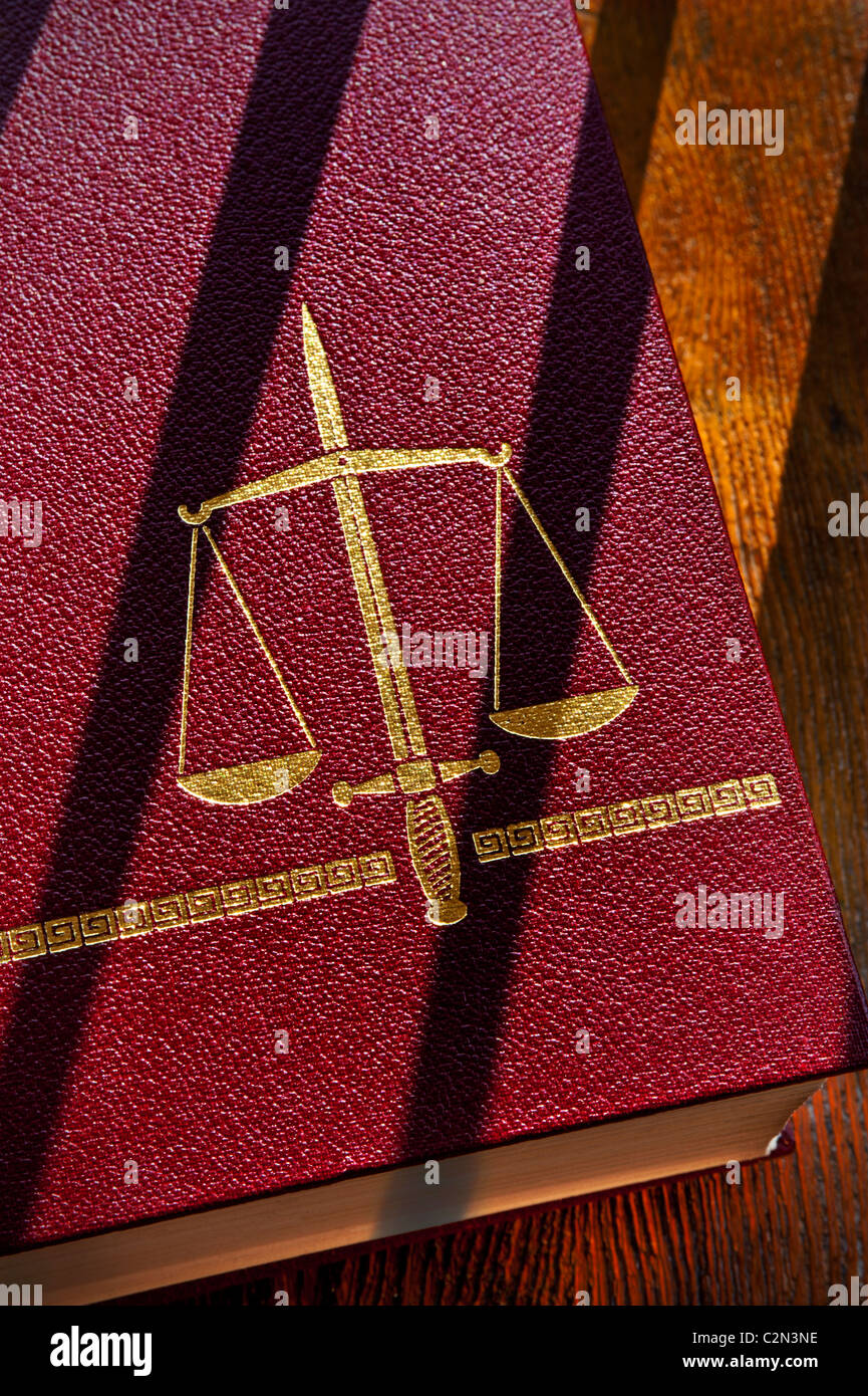 Sentence Law Courts Jail Prison Legal Court Concept laws book with Scales of Justice with double edged sword motif & shadows of prison bars glancing Stock Photo