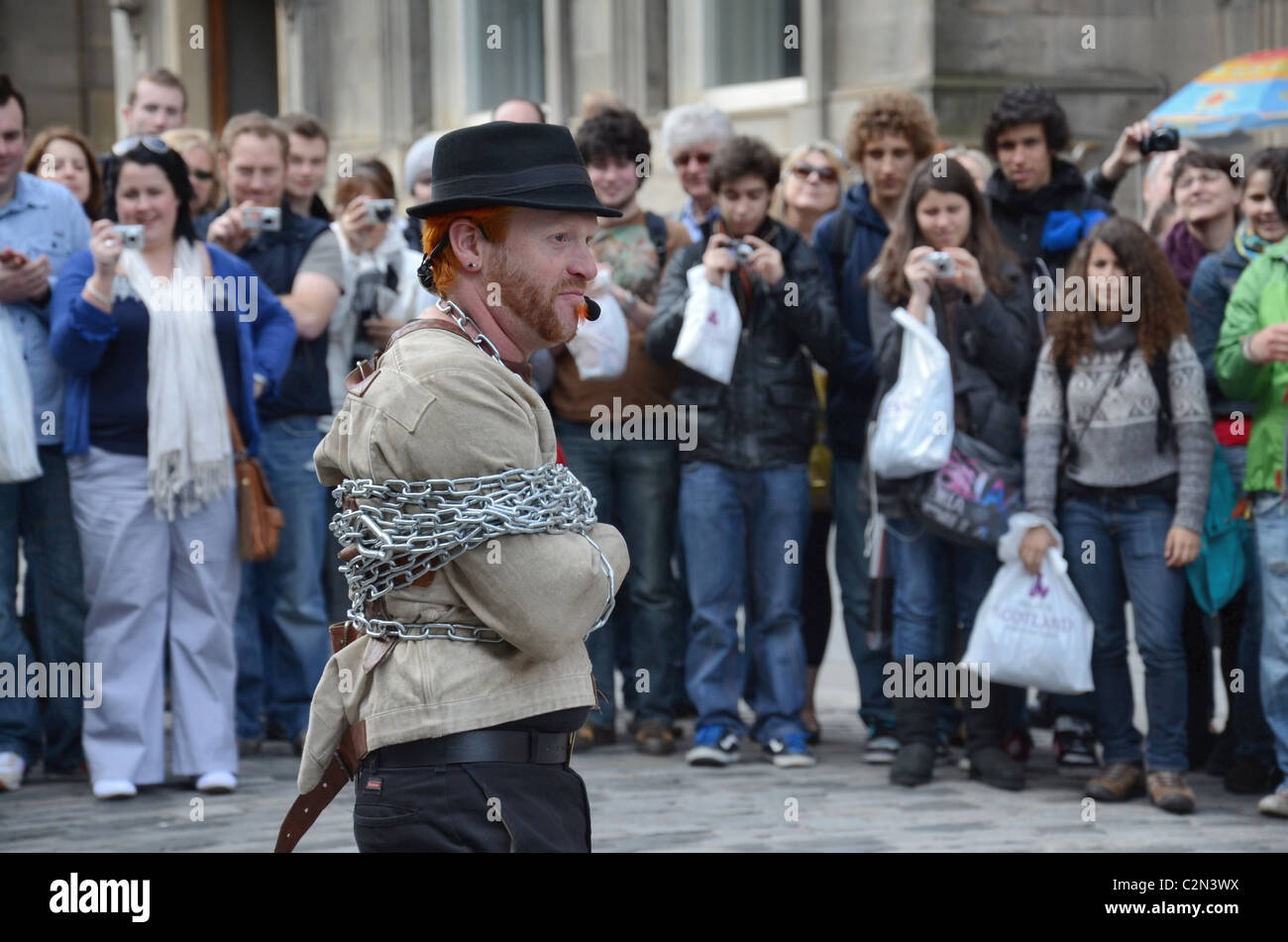 A street performer entertains the crowd on the Edinburgh's Royal Mile. Stock Photo