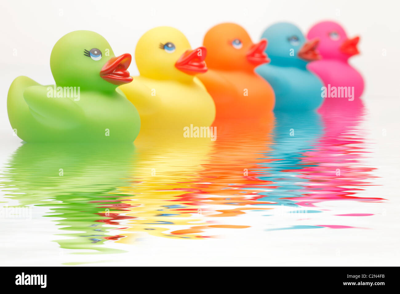 Colourful Rubber Ducks with water ripples Stock Photo