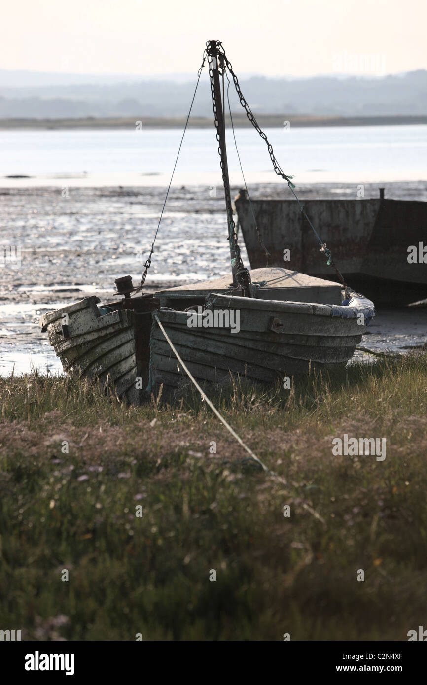 Old fishing boat moored up on bank Stock Photo
