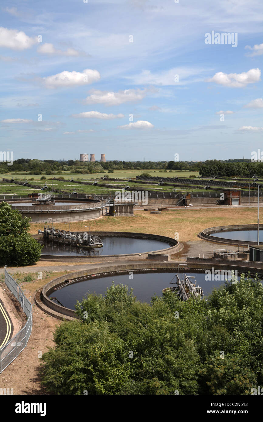 Sewage treatment plant with power station in the distance Stock Photo