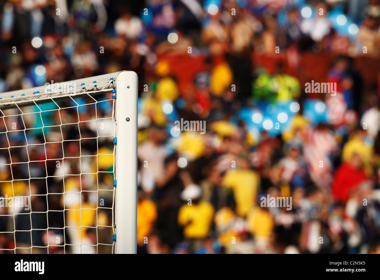 Soccer goal detail with colorful stadium background. Stock Photo
