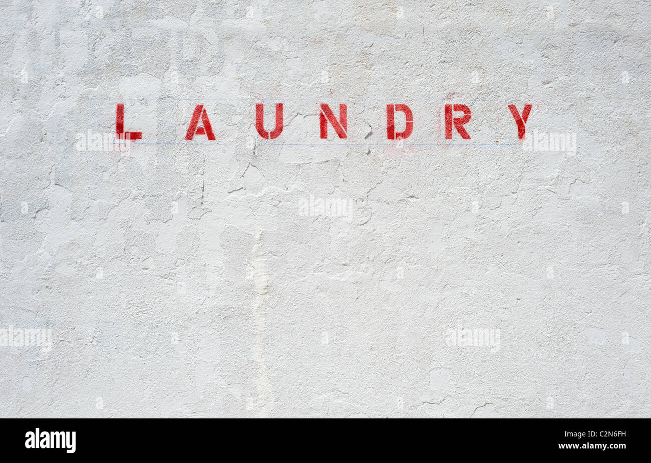 Lettering on an old stucco wall of an abandoned laundry in Carrizozo, New Mexico. Stock Photo