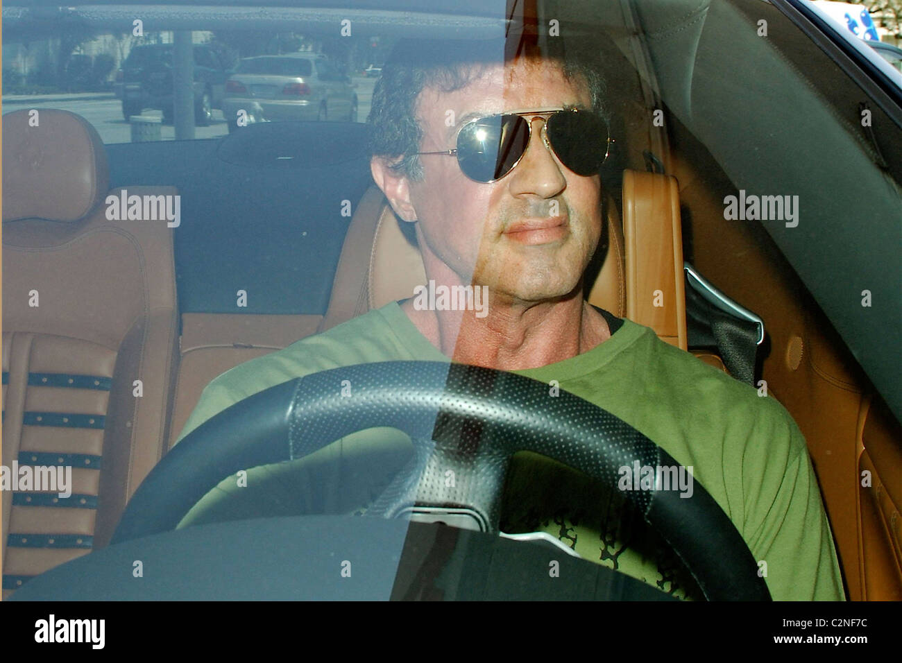 Sylvester Stallone fills up his Ferrari with gas at a 76 gas station in