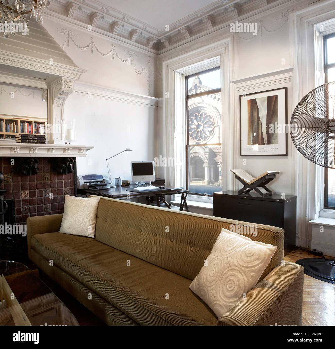 Brooklyn brownstone interior moulded ceiling, overmantel and large sofa Stock Photo