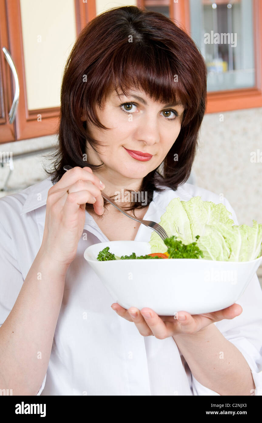 Beautiful a woman to taste cooked the food Stock Photo
