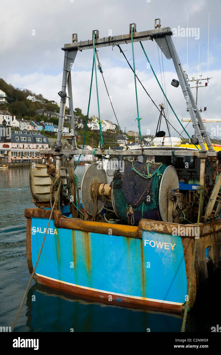 Cornish fishing boat with fishing net / nets and gear, moored at the quay / quayside in the harbour at Looe in Cornwall. UK. Stock Photo