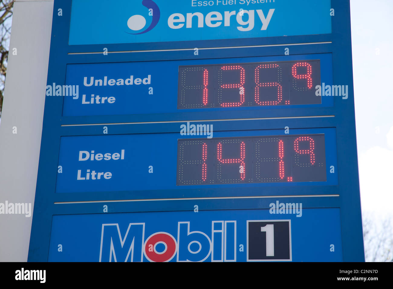 Petrol prices on illuminated Esso sign board Stock Photo