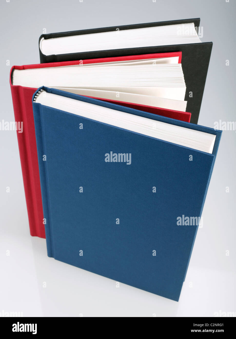 Three books with plain, hard covers Stock Photo