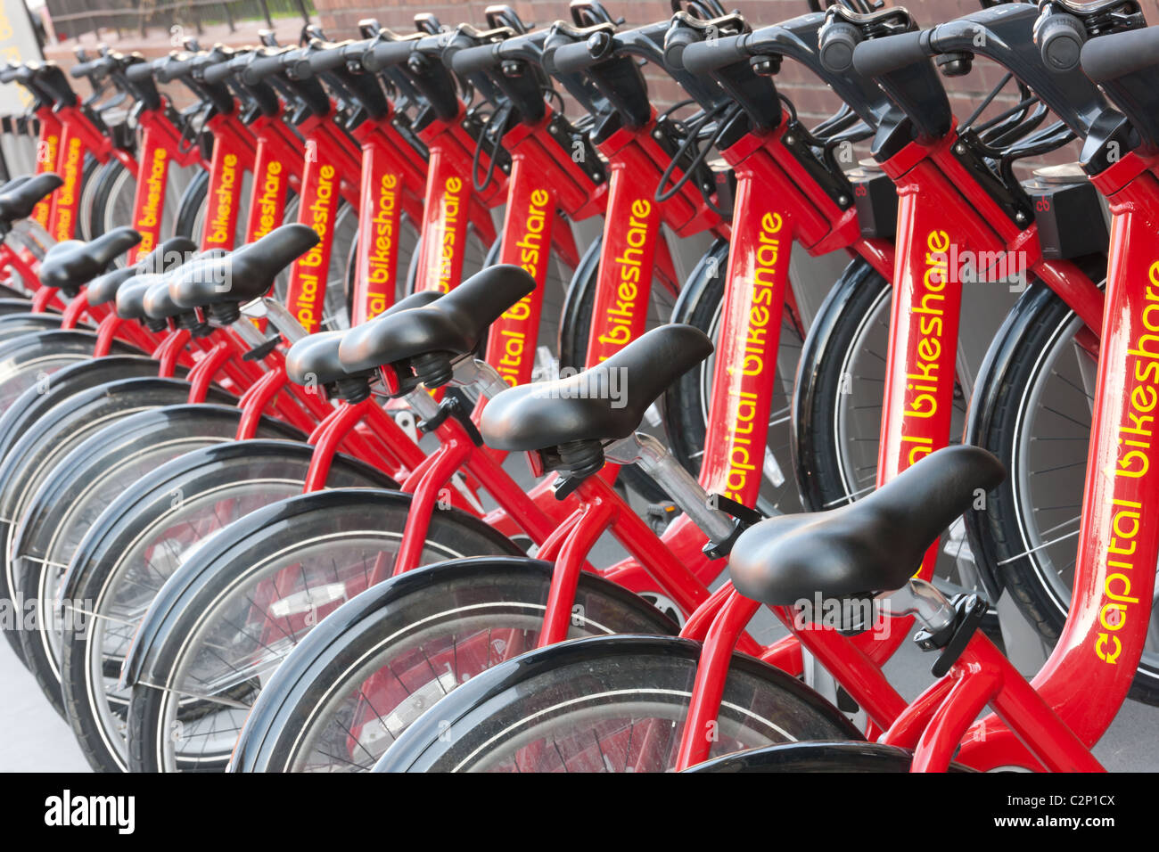 Public bicycles of the Capital Bikeshare bike sharing program docked in a docking station on a street in Washington, DC. Stock Photo