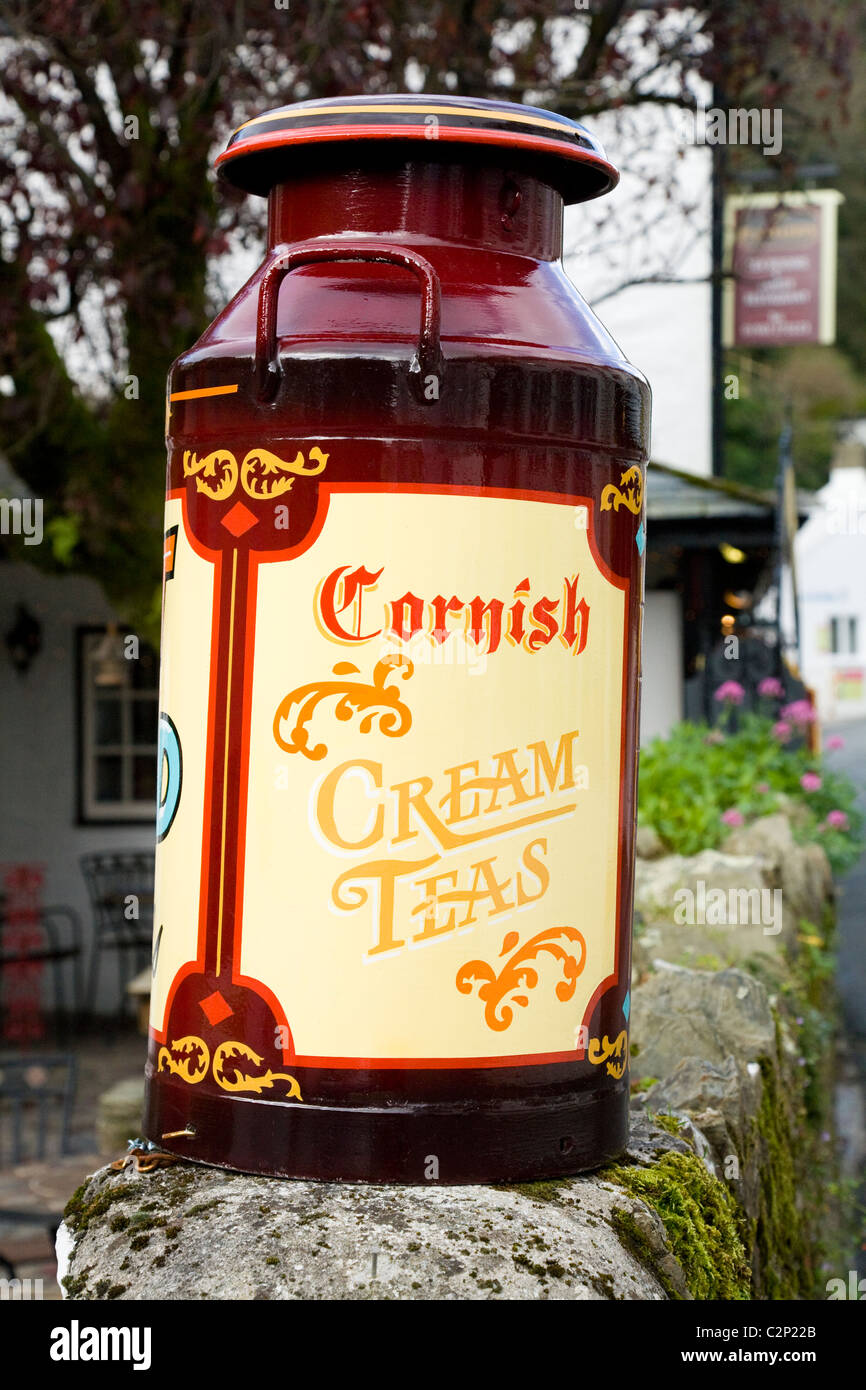 Milk churn decorated to advertise Cornish cream teas / cream tea advertisement in Polperro. Cornwall. UK. Stock Photo