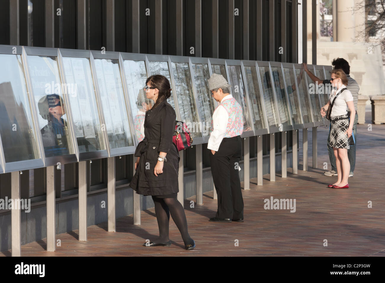 People read the front pages of the day's newspapers in front of the Newseum museum of news in Washington, DC. Stock Photo