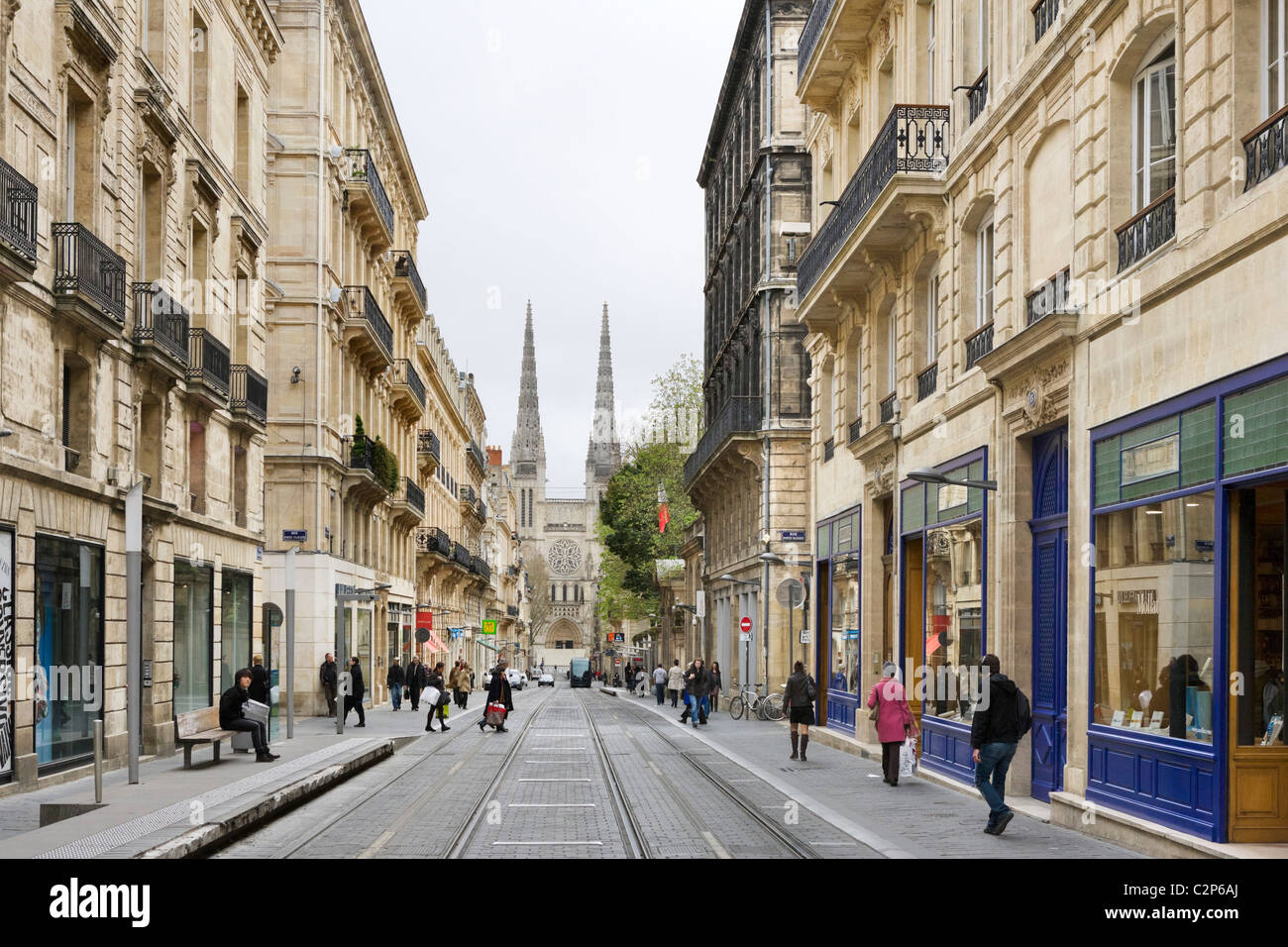 Shops on Rue Vital-Carles with spires of the Cathedral St Andre in background, Quartier St Pierre, Bordeaux, Aquitaine, France Stock Photo