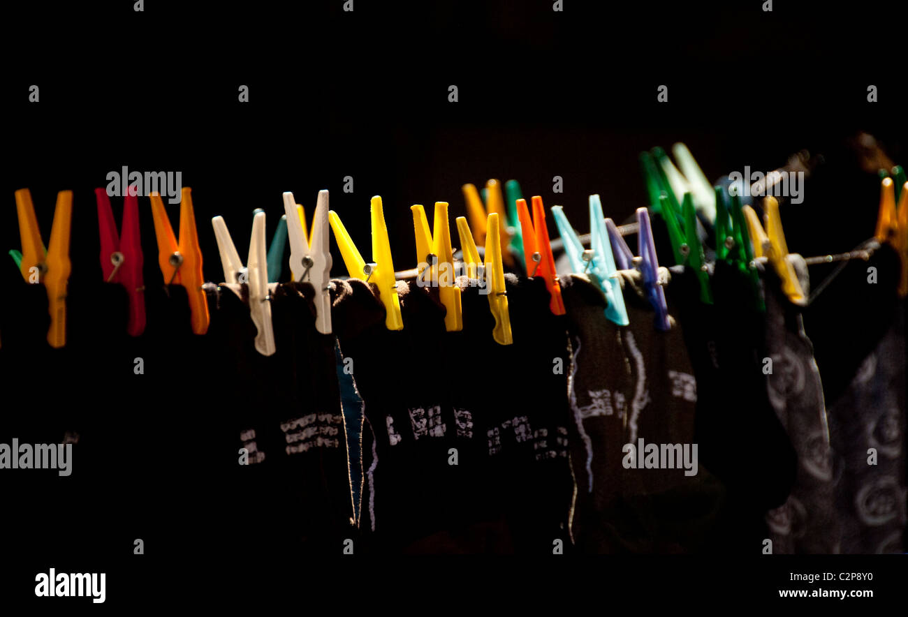 Colourful plastic clothes pegs on a Lisbon washing line Stock Photo