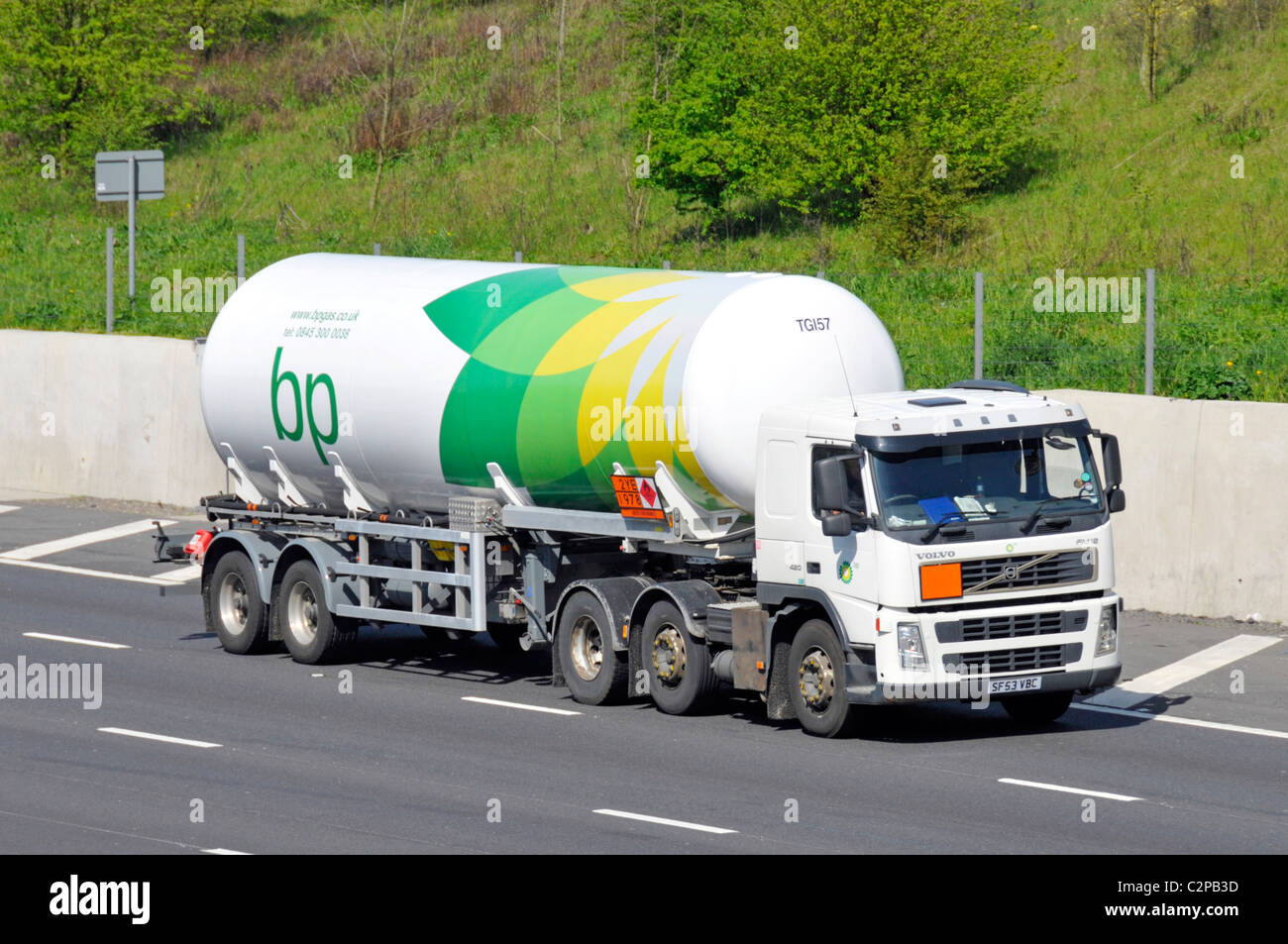 BP gas tanker trailer and white hgv lorry truck with Hazchem Hazardous Chemicals Dangerous Goods & material warning sign England UK Stock Photo
