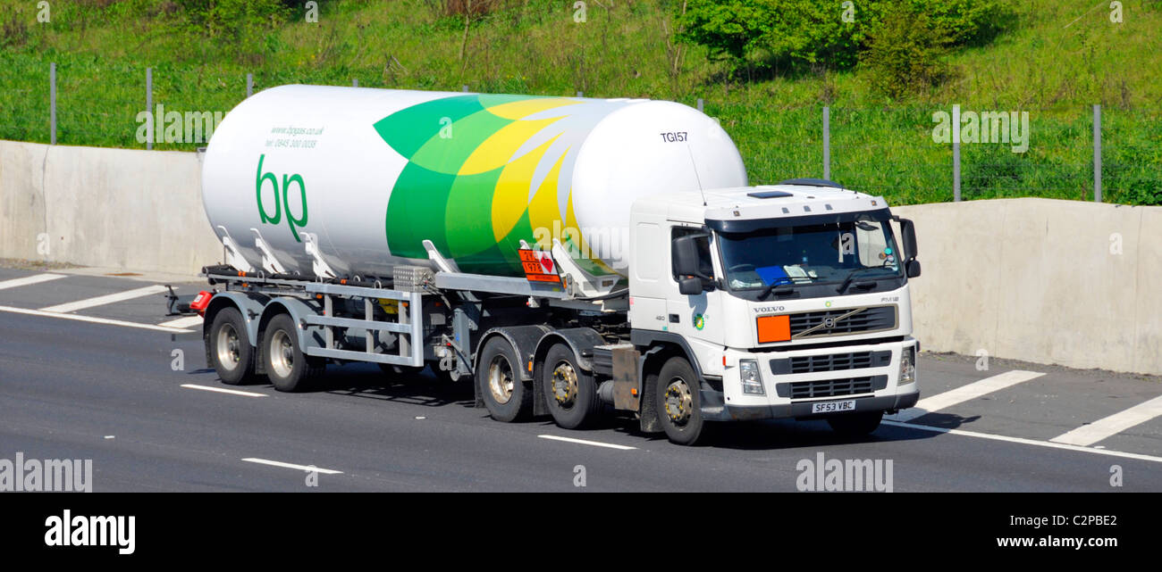 BP brand logo gas tanker trailer & Volvo prime mover hgv lorry truck driver with Hazchem Hazardous Chemicals and Dangerous Goods warning sign England Stock Photo