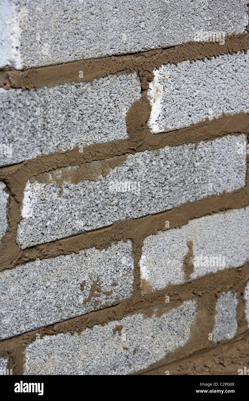 bricklaying wall with half cement breeze blocks building a block