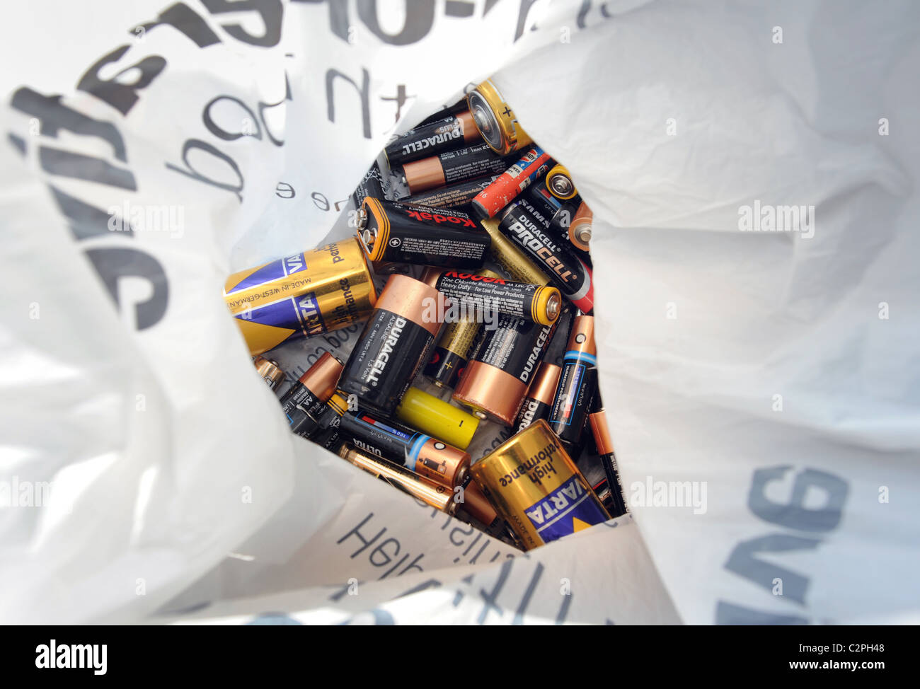 USED BATTERIES IN PLASTIC CARRIER BAG READY TO BE RECYCLED RE RECYCLING