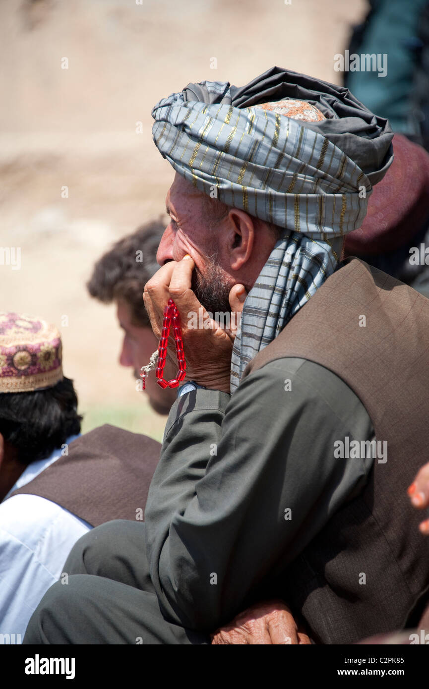 Afghan man with prayer beads in Helmand Stock Photo