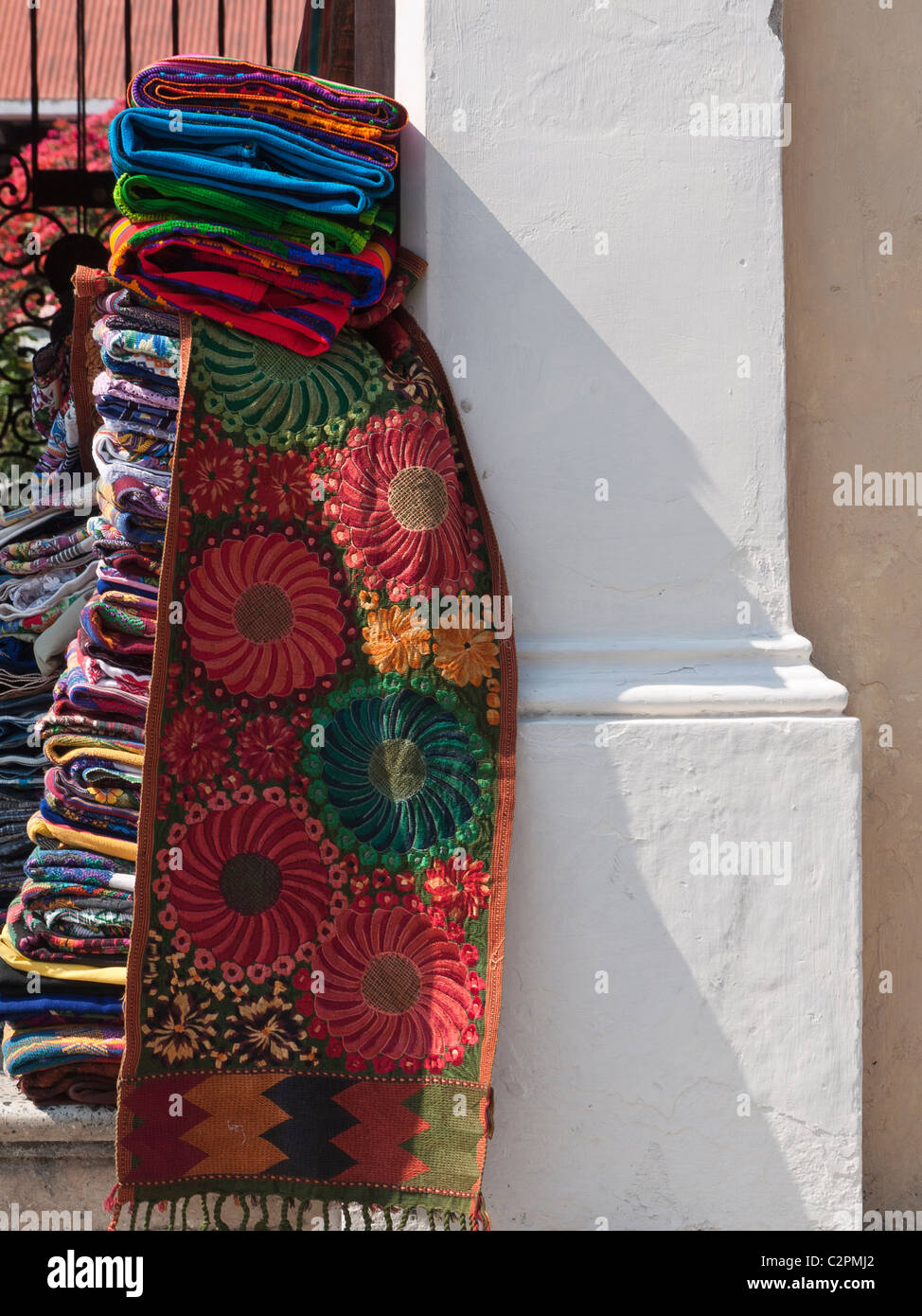 Hand crafted colorful traditional Guatemalan blankets stacked outside