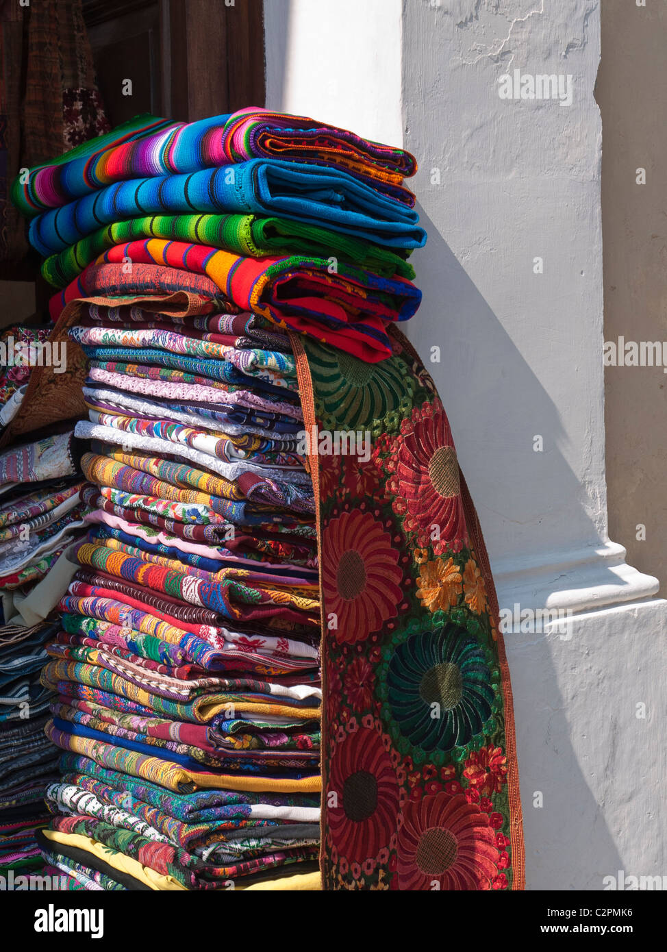Hand crafted colorful traditional Guatemalan blankets stacked outside
