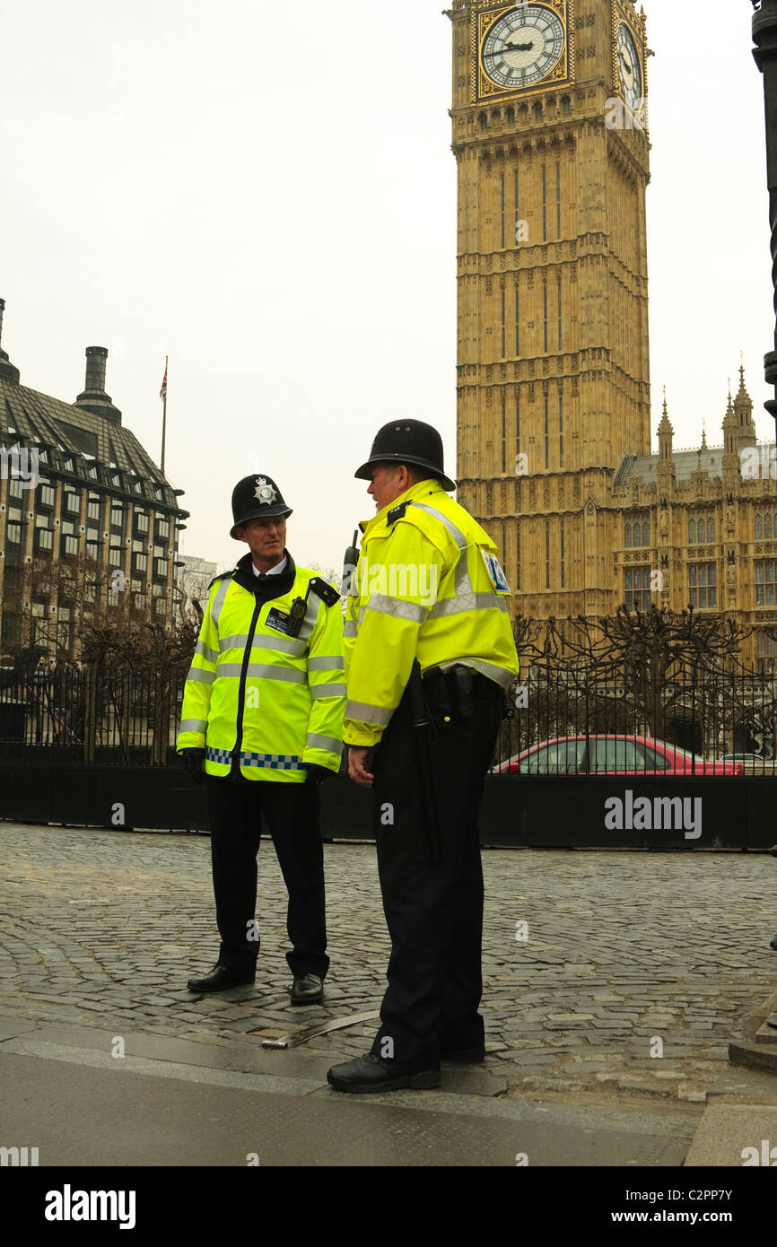 Two policemen stand outside the Houses of parliament guarding against ...