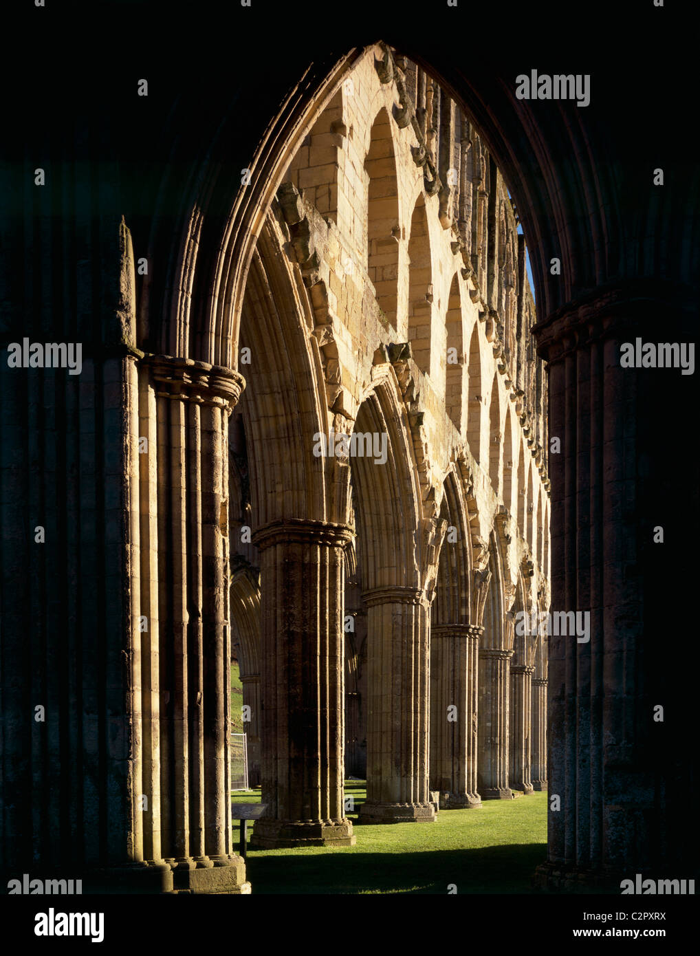 Rievaulx Abbey. View through silhouetted arch to Presbytery arcade looking NE. Stock Photo