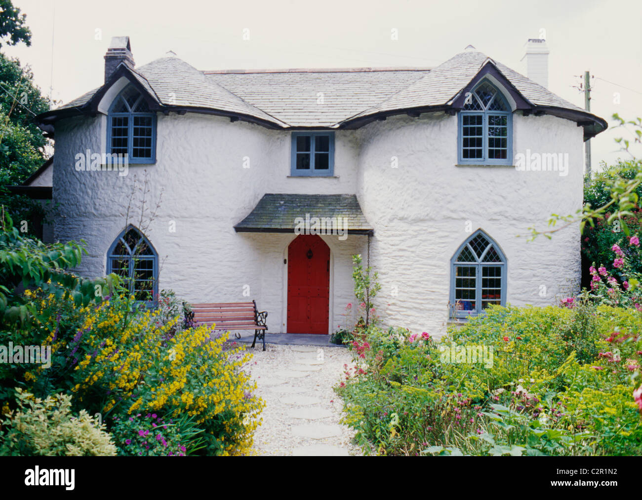 Cottage c.1790s; Picturesque features: gothick windows and circular bays, Regency style, summer garden. Philleigh, Cornwall. Stock Photo