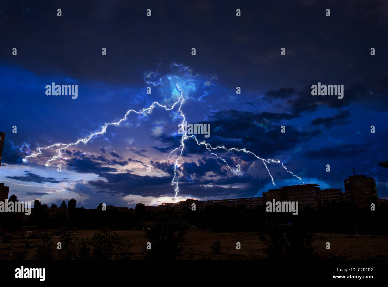 Lightning and storm clouds over the city evening Stock Photo