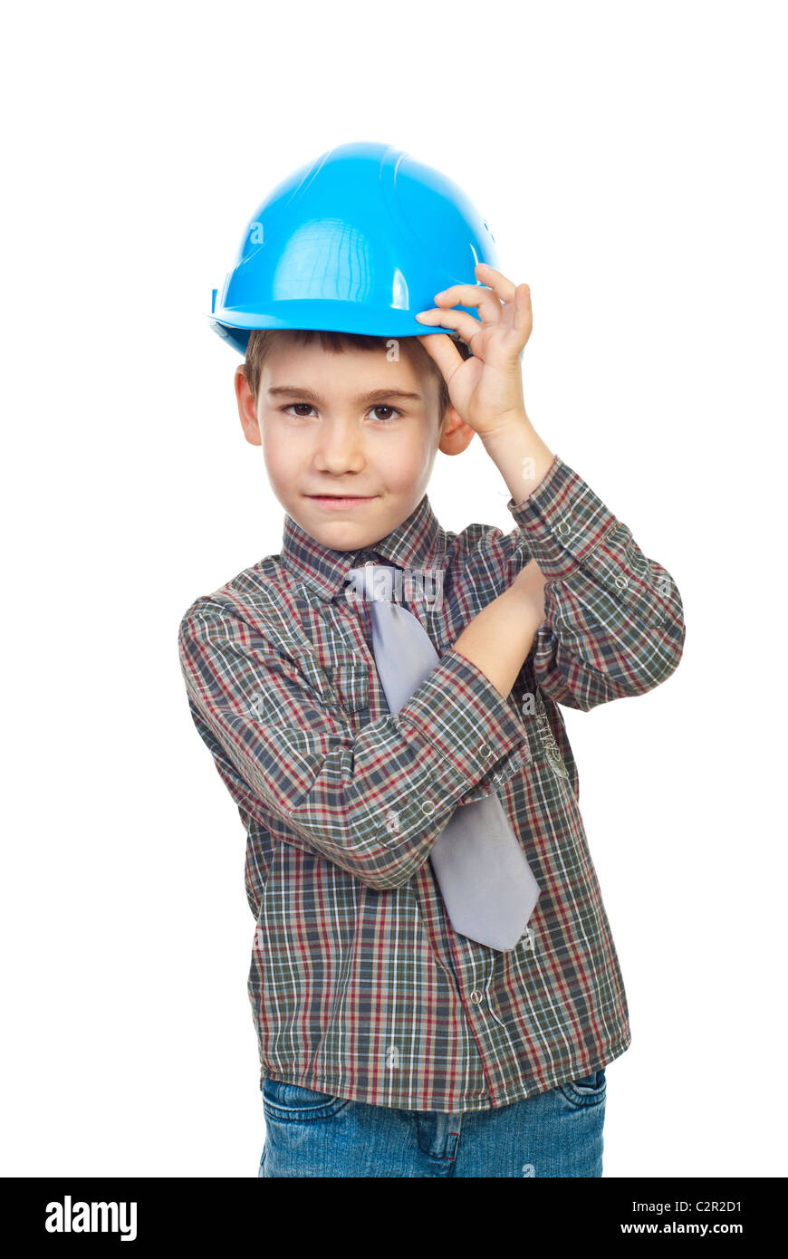 Six years old boy smiling and holding his hard hat isolated on white background Stock Photo