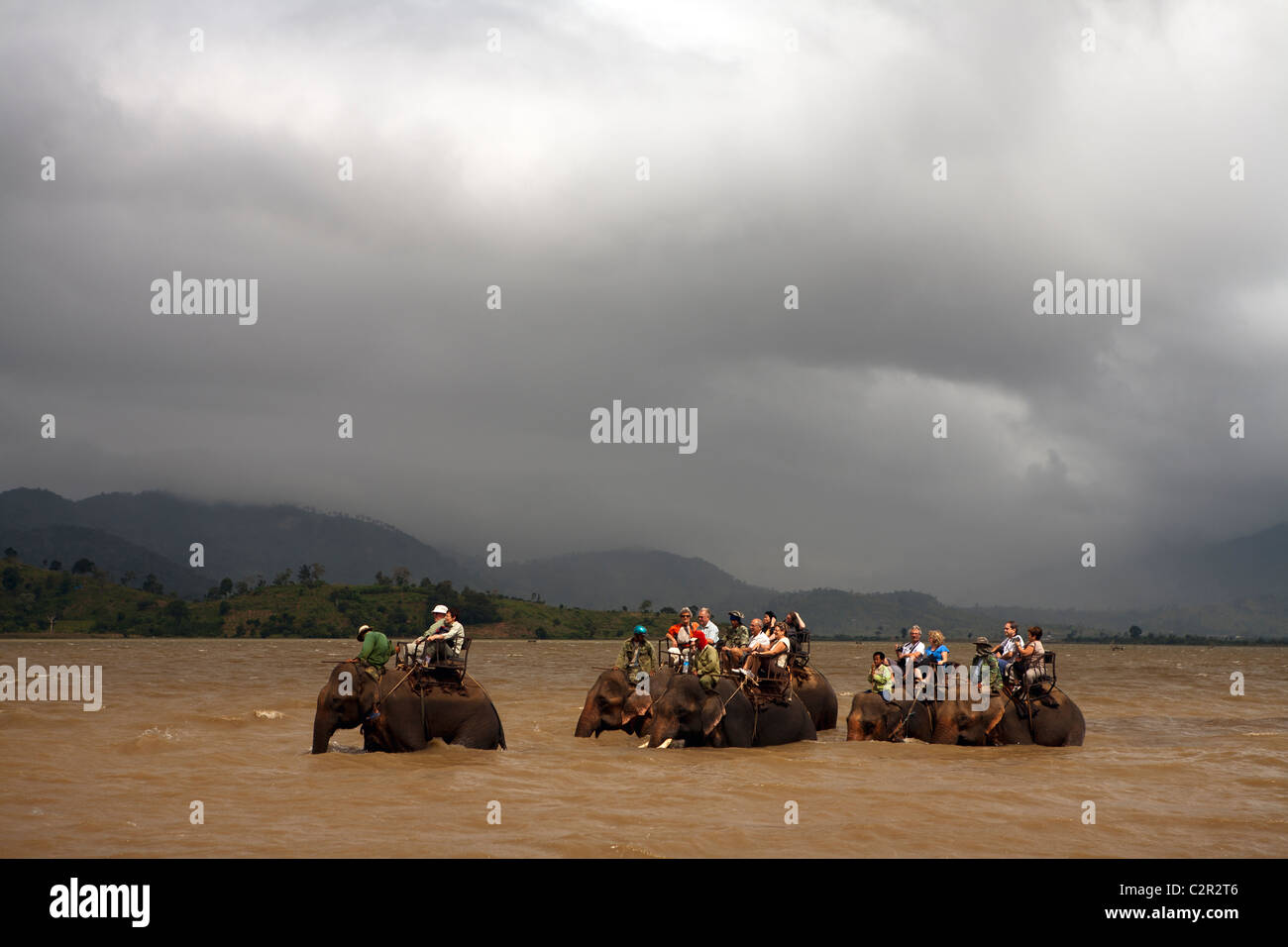 Elephant rides through Lak Lake in Vietnam's Highlands Stock Photo