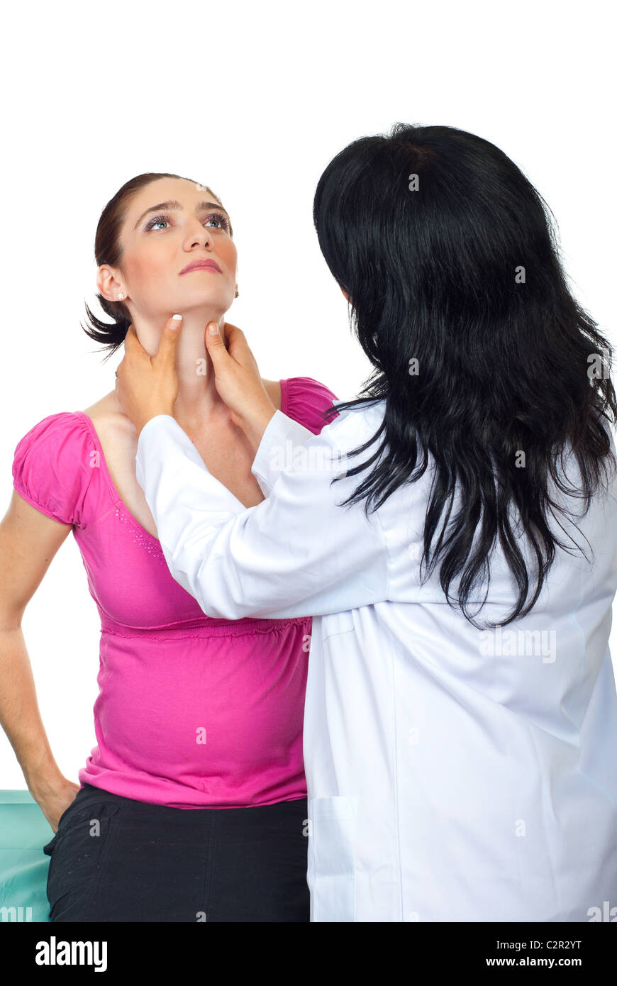 Doctor endocrinologist checking thyroid goiter of pregnant woman and holding hands on her throat Stock Photo