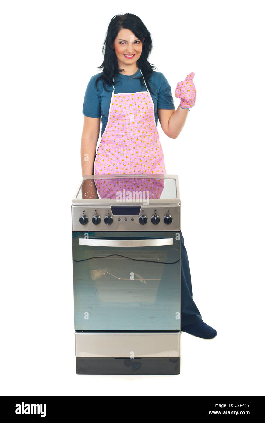 Successful cook woman with new electrical stove giving thumb up in her